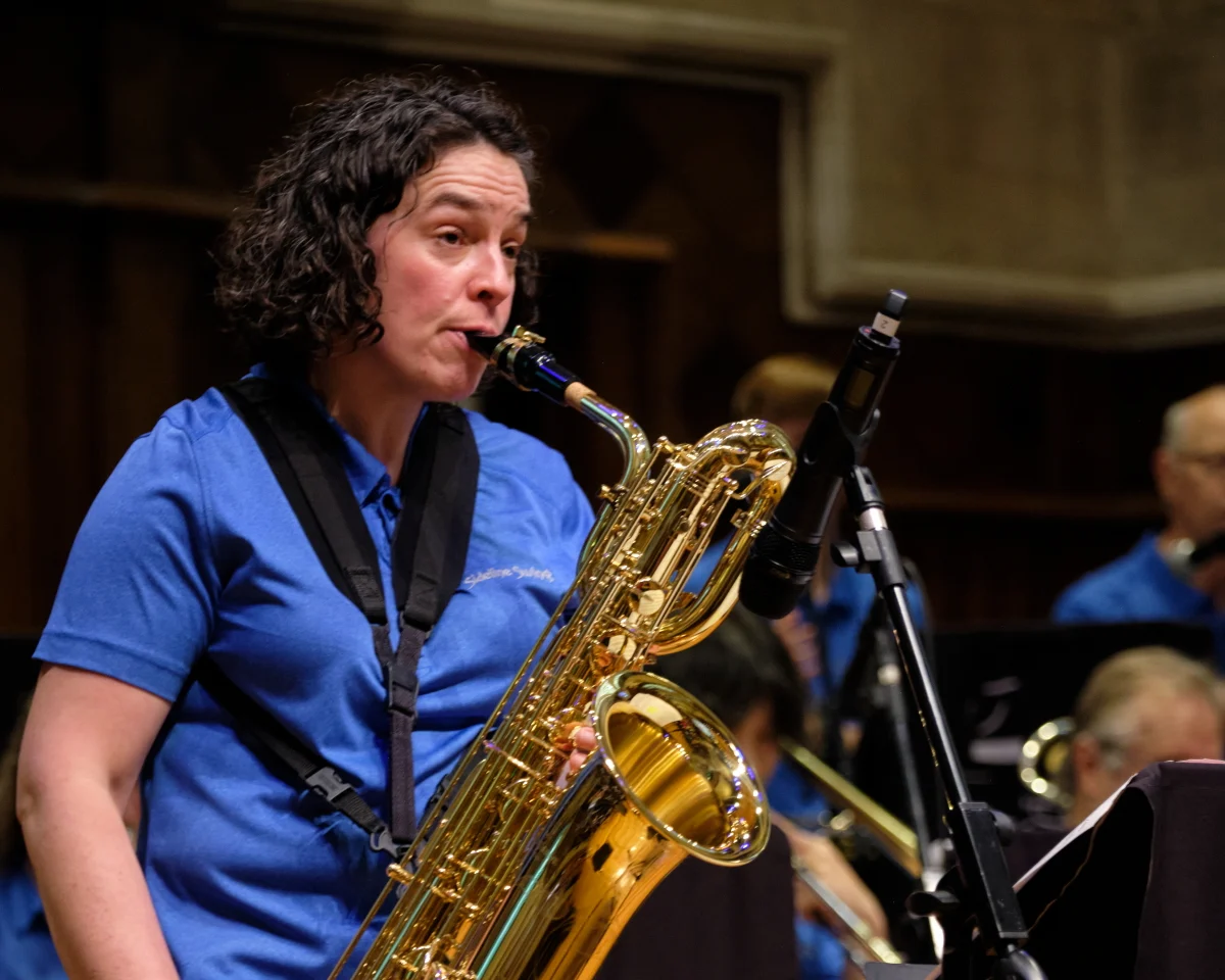 Caroline playing baritone saxophone with a swing band