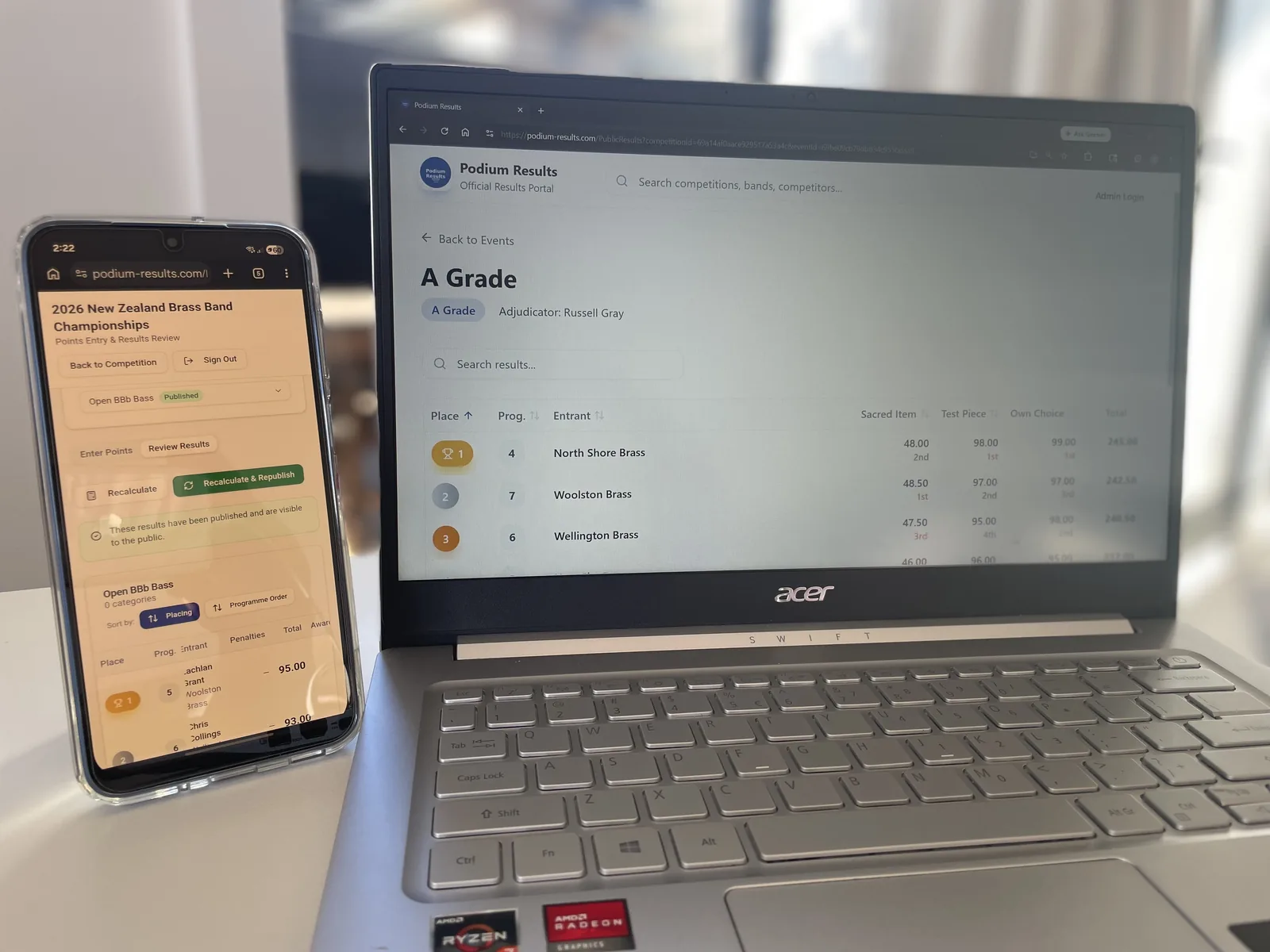 Podium Results running on a laptop and phone at a competition venue
